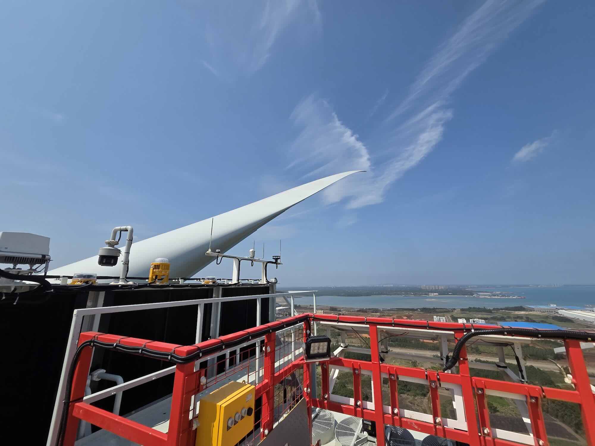 Wind turbine blade and service lift against open sky
