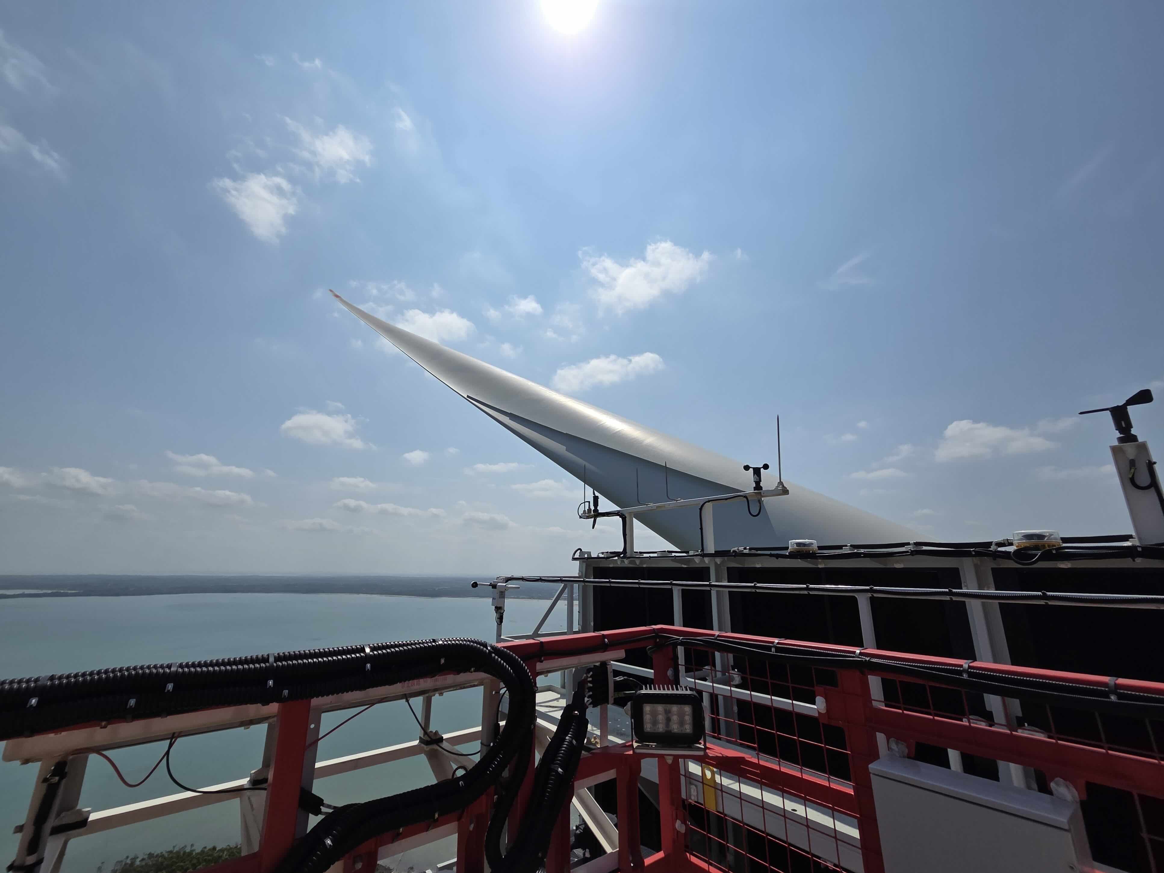 Wind turbine blade and maintenance platform above open water